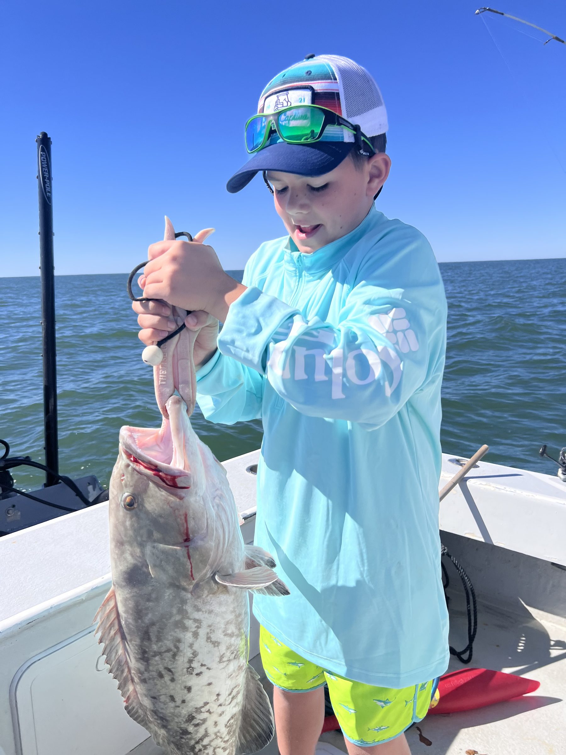 A young angler with his catch on the Gulf